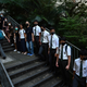Students, alumni, and teachers in the Mid-Levels area of Hong Kong take part in a human chain.